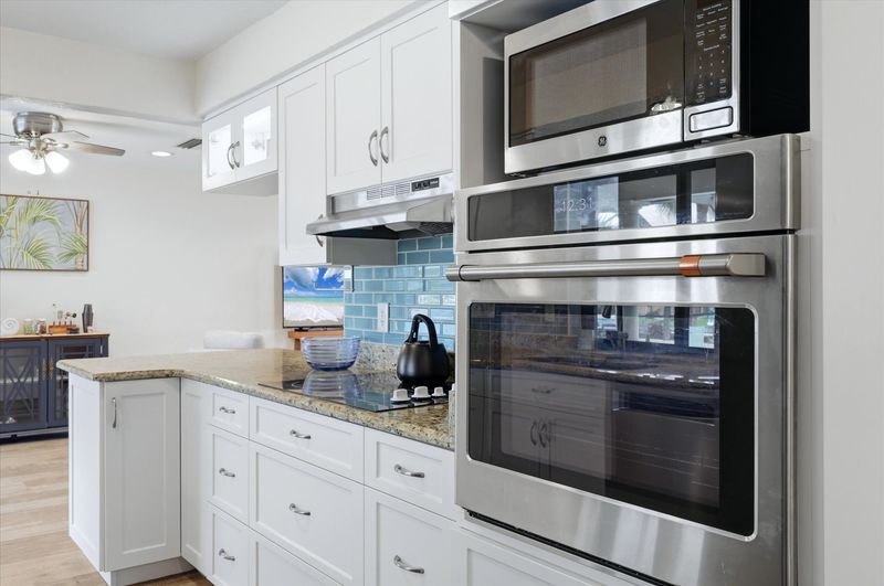 Bright, fully-equipped kitchen overlooking the pool and canal
