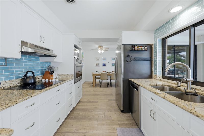 Bright, fully-equipped kitchen overlooking the pool and canal