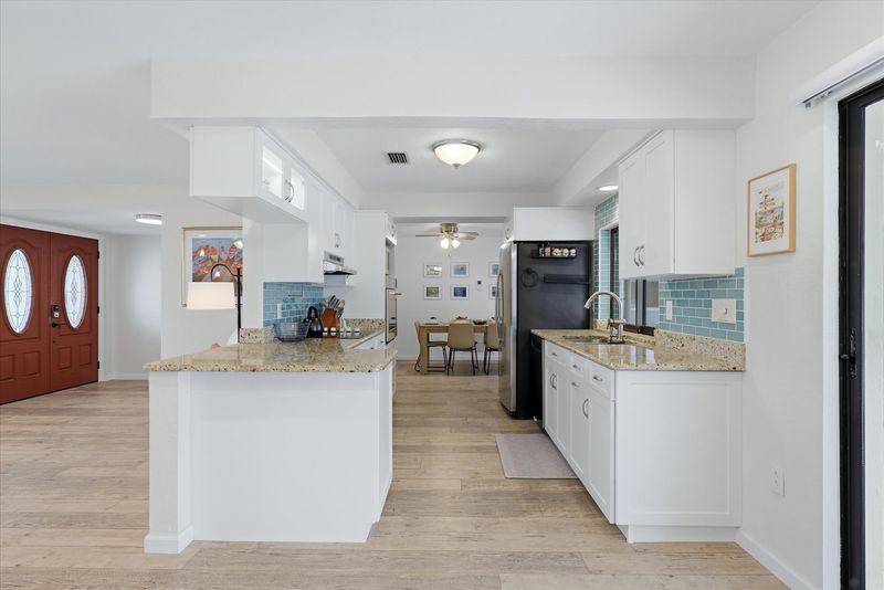 Bright, fully-equipped kitchen overlooking the pool and canal