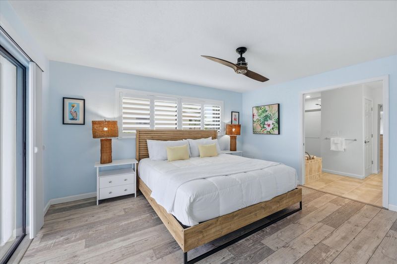 Bedroom 1 - Primary bedroom with king bed, attached bathroom, lanai access, and 43-inch Smart TV