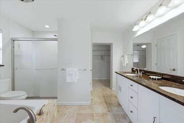 Primary bedroom attached bathroom with walk-in shower, soaking tub, and double vanities