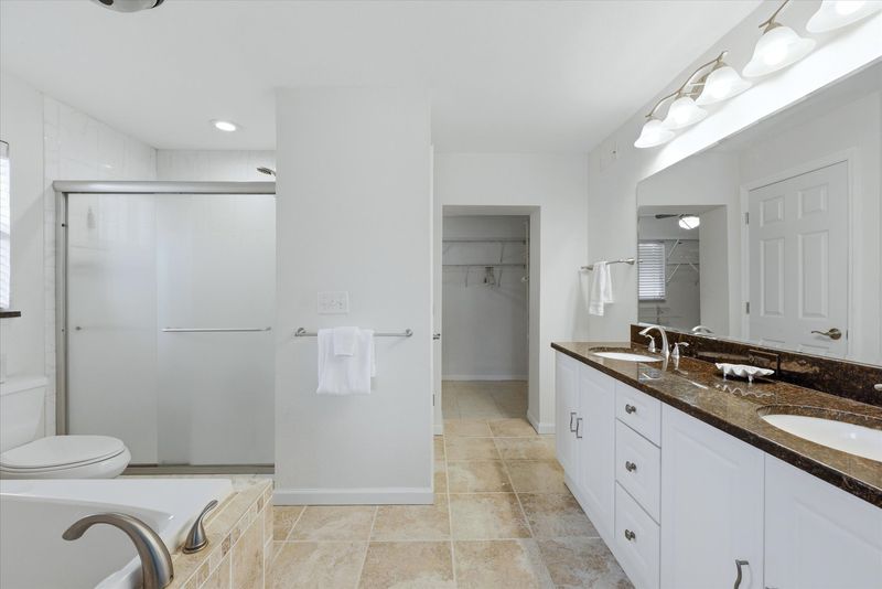Primary bedroom attached bathroom with walk-in shower, soaking tub, and double vanities