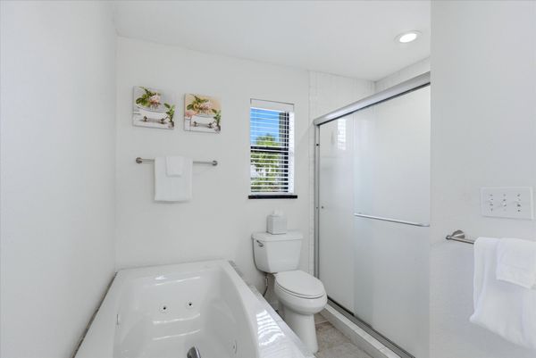 Primary bedroom attached bathroom with walk-in shower, soaking tub, and double vanities