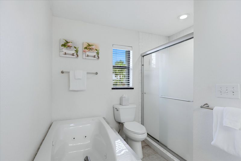 Primary bedroom attached bathroom with walk-in shower, soaking tub, and double vanities