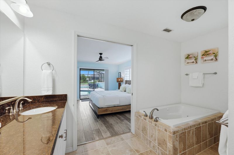 Primary bedroom attached bathroom with walk-in shower, soaking tub, and double vanities