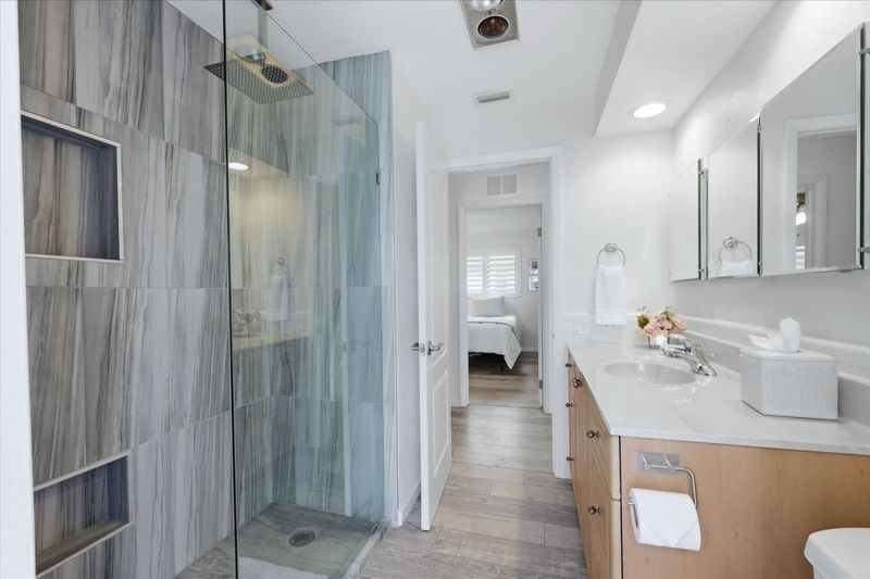 Guest bathroom with walk-in shower and lanai access