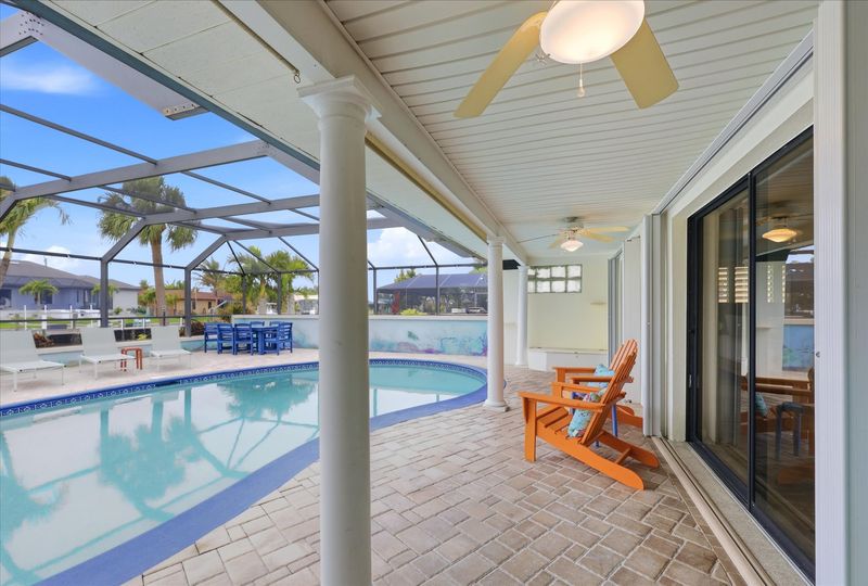 Large lanai with private sparkling pool is perfect for entertaining. Features sun loungers, dining table that seats 6, and 43-inch Smart TV