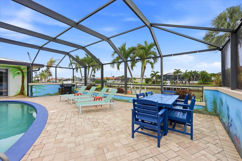Large lanai with private sparkling pool is perfect for entertaining. Features sun loungers, dining table that seats 6, and 43-inch Smart TV