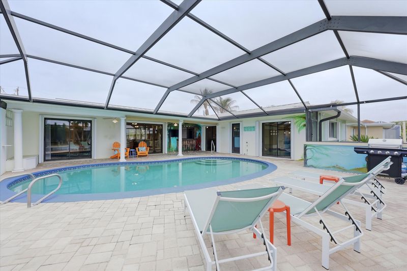 Large lanai with private sparkling pool is perfect for entertaining. Features sun loungers, dining table that seats 6, and 43-inch Smart TV