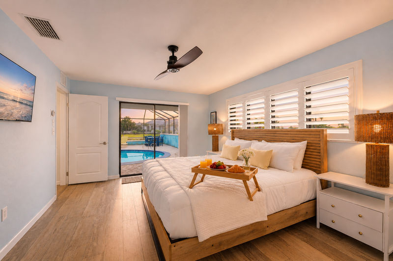 Bedroom 1 - Primary bedroom with king bed, attached bathroom, lanai access, and 43-inch Smart TV