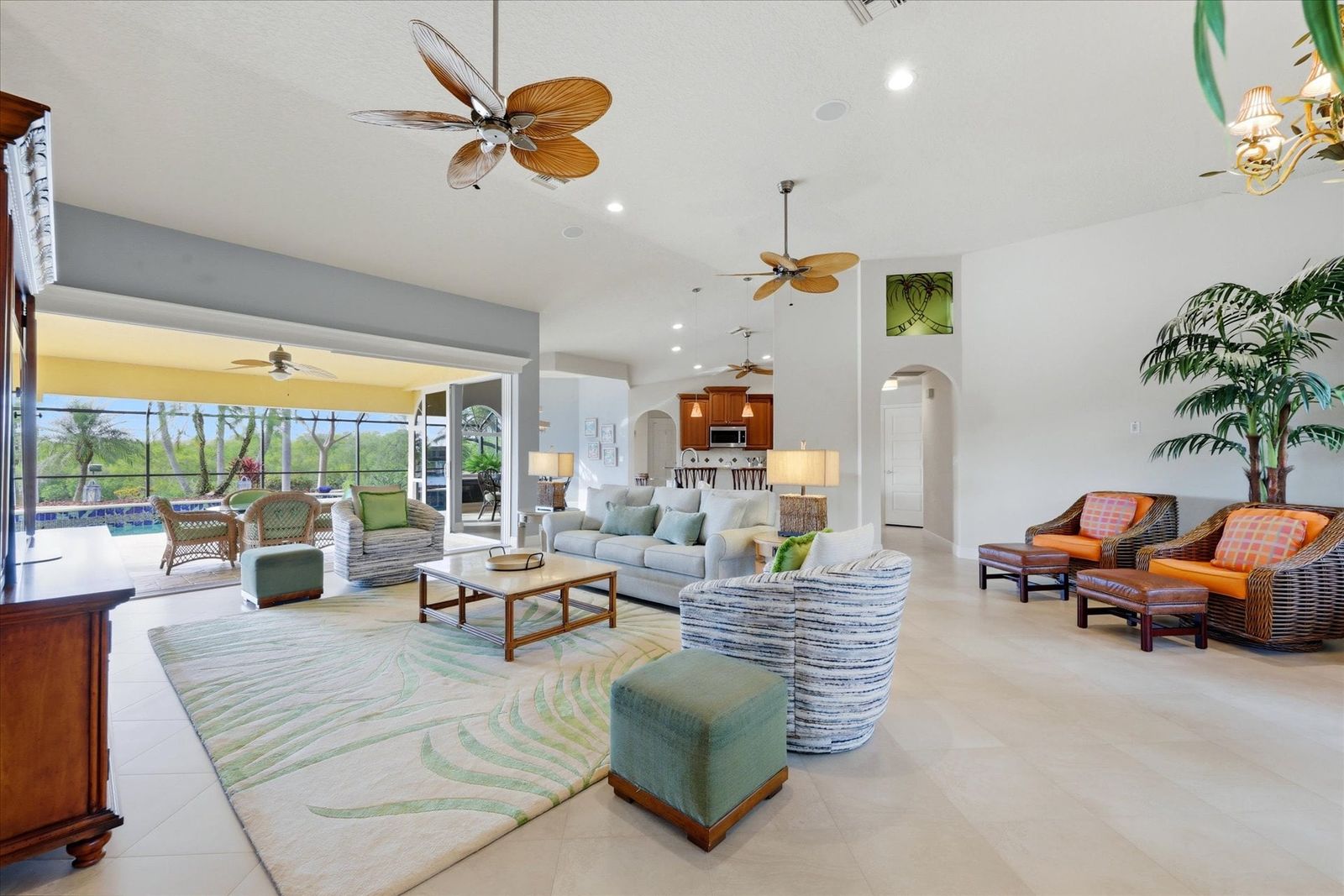 Large open living space overlooking the pool & canal beyond. Living room features lots of seating and 65-inch Smart TV