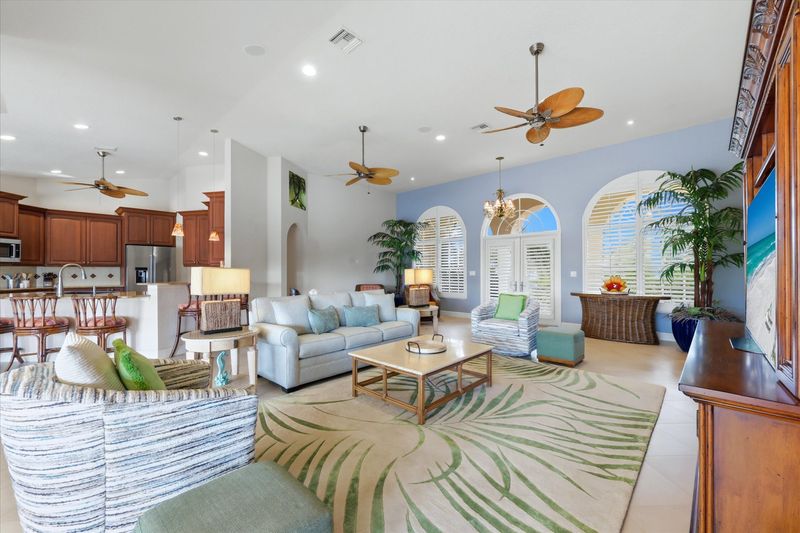 Large open living space overlooking the pool & canal beyond. Living room features lots of seating and 65-inch Smart TV