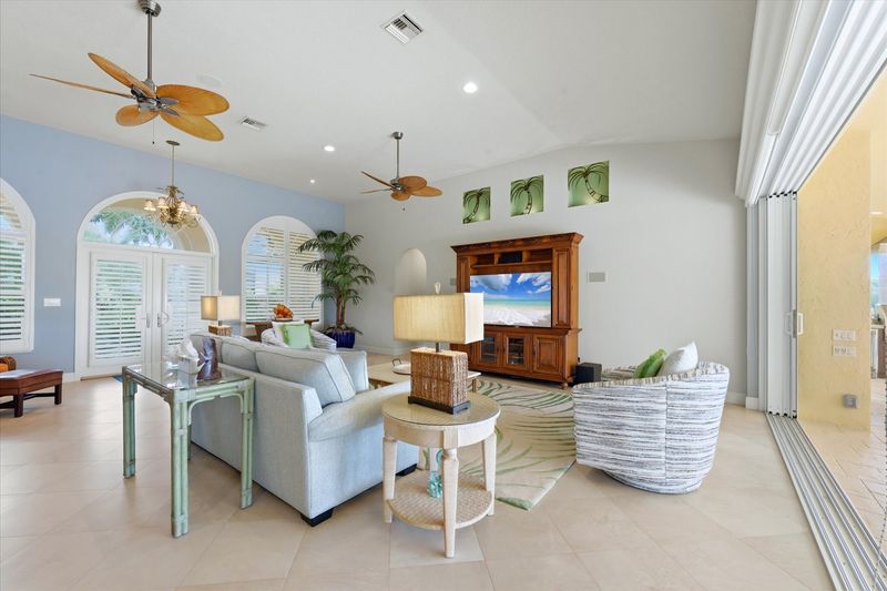 Large open living space overlooking the pool & canal beyond. Living room features lots of seating and 65-inch Smart TV