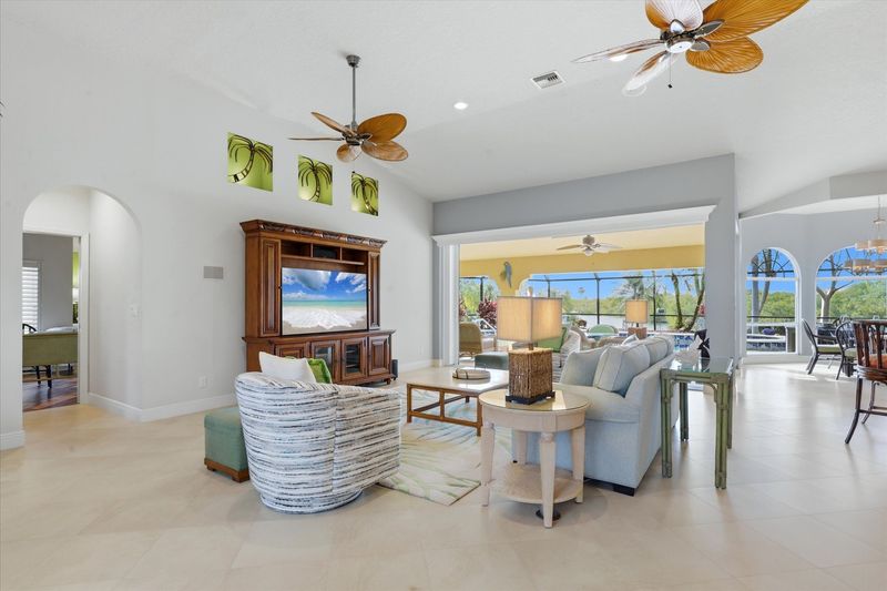 Large open living space overlooking the pool & canal beyond. Living room features lots of seating and 65-inch Smart TV