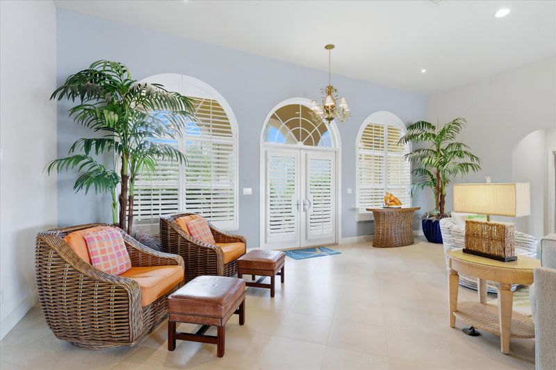 Large open living space overlooking the pool & canal beyond. Living room features lots of seating and 65-inch Smart TV