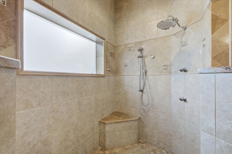 Primary bedroom en suite with walk-in shower & double vanities