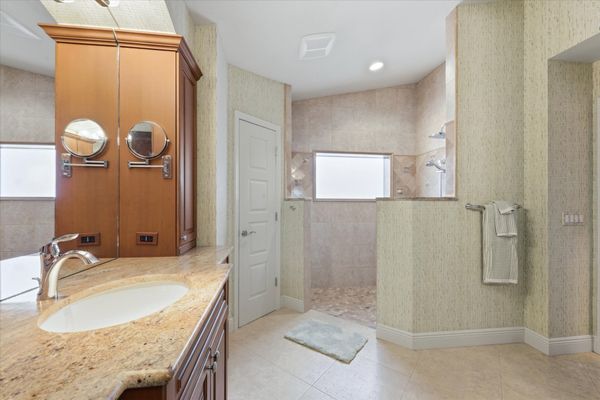 Primary bedroom en suite with walk-in shower & double vanities