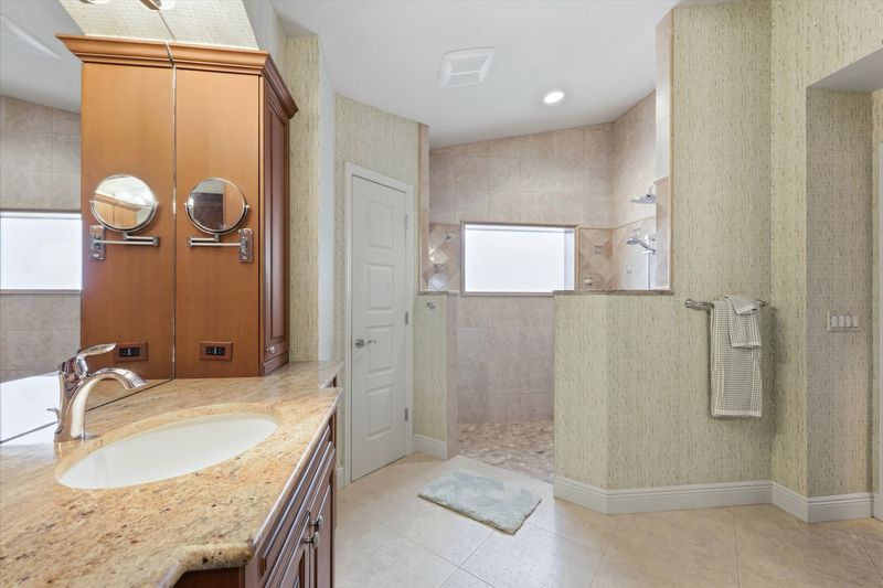 Primary bedroom en suite with walk-in shower & double vanities