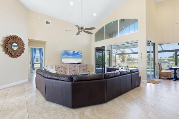 Family room with large sectional sofa, lanai access and 75-inch Smart TV