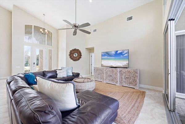 Family room with large sectional sofa, lanai access and 75-inch Smart TV