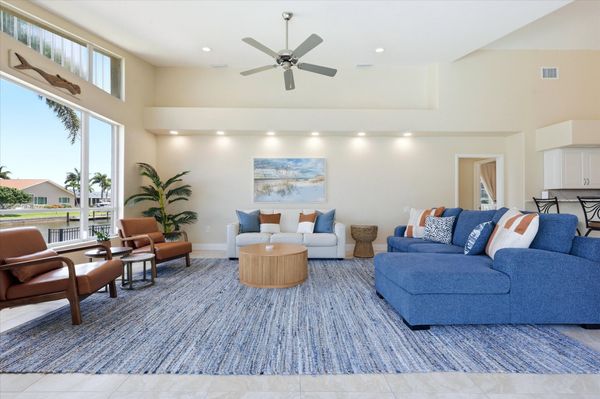 Living room overlooking the pool with lots of comfortable seating and fantastic waterviews
