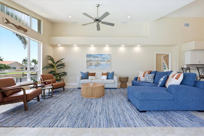Living room overlooking the pool with lots of comfortable seating and fantastic waterviews