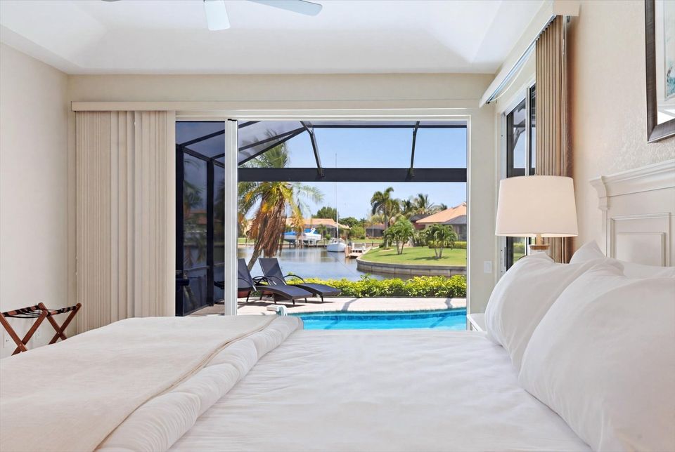 Bedroom 1 - Primary bedroom with king bed, attached bathroom, lanai access, and 43-inch Smart TV