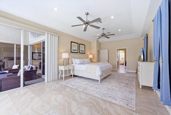 Bedroom 1 - Primary bedroom with king bed, attached bathroom, lanai access, and 43-inch Smart TV