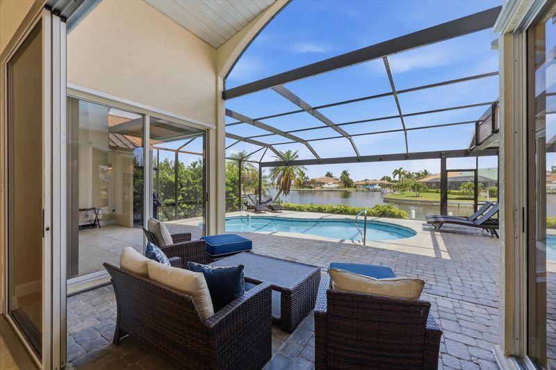 Great outdoor living space overlooking the canal. Features a sparkling pool, sun loungers, and BBQ grill. Pool size: 25' x 13' x 6'D