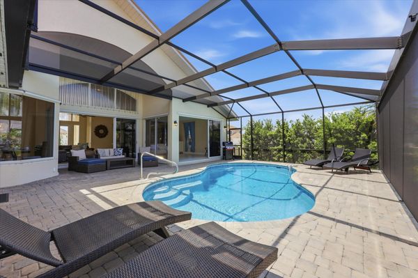 Great outdoor living space overlooking the canal. Features a sparkling pool, sun loungers, and BBQ grill. Pool size: 25' x 13' x 6'D