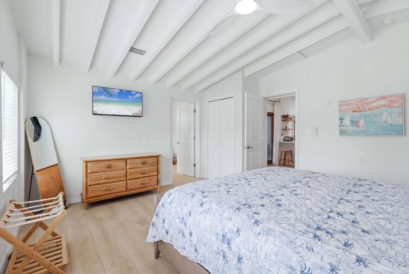 Primary bedroom with king bed, attached bathroom and 40-inch Smart TV