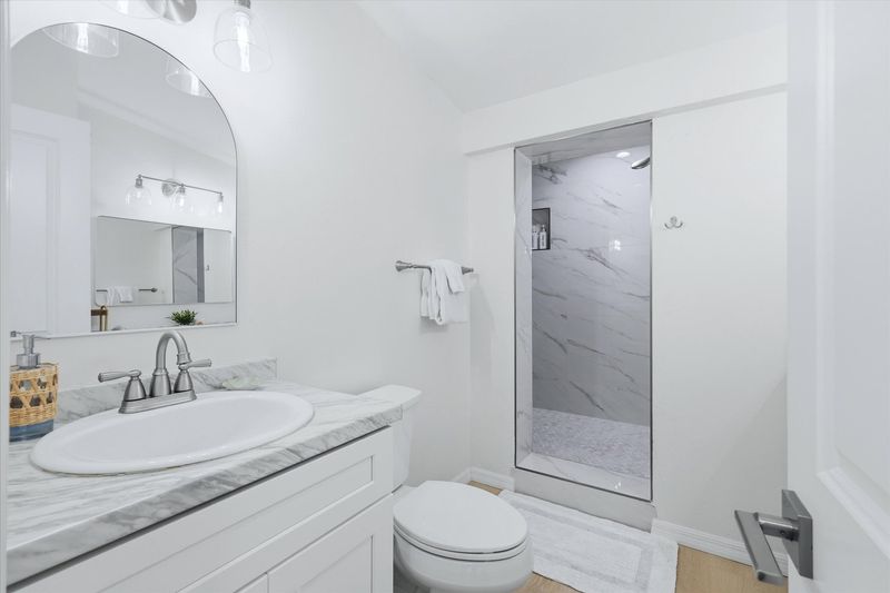 Primary bedroom's attached bathroom with large walk-in shower