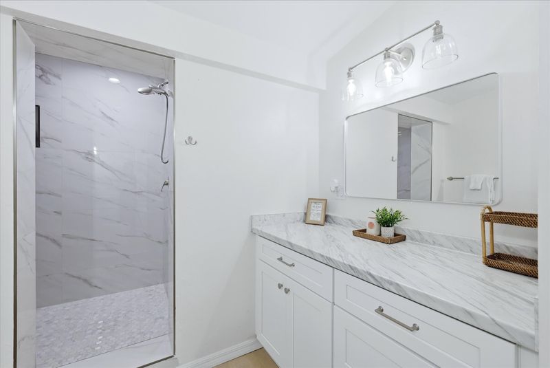 Primary bedroom's attached bathroom with large walk-in shower