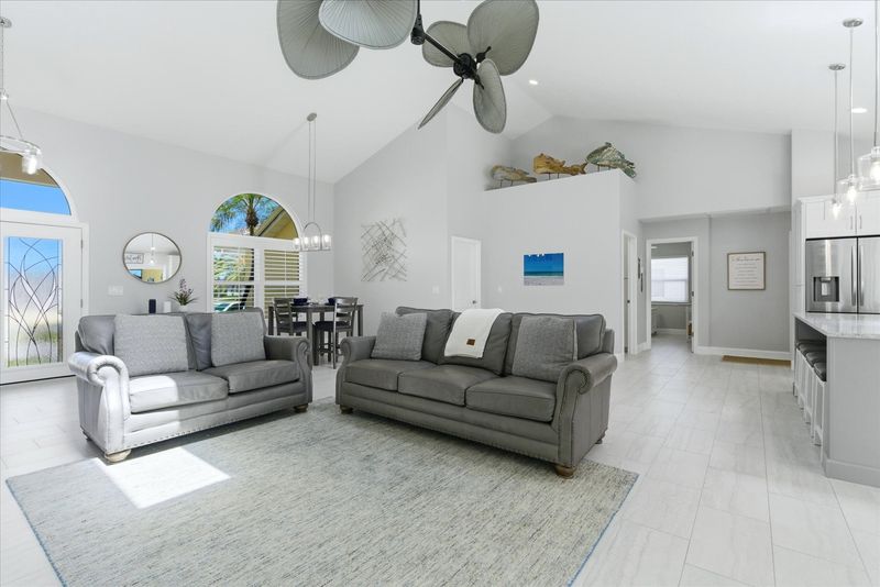 Living room features lots of comfy seating, 70" Smart TV with sound system