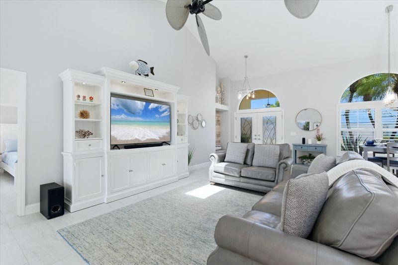 Living room features lots of comfy seating, 70" Smart TV with sound system