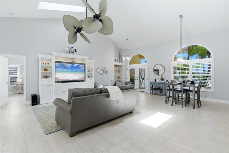 Living room features lots of comfy seating, 70" Smart TV with sound system