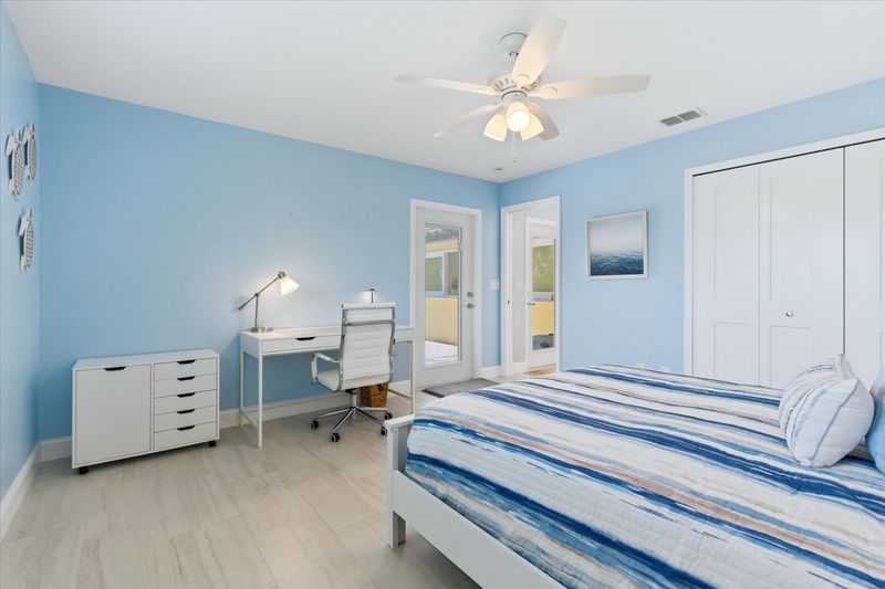 Bedroom 4 with queen bed, desk & chair, and 43" Smart TV