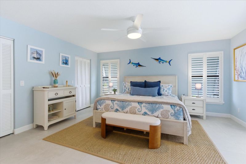 Bedroom 1 - primary bedroom with king bed, attached bathroom, lanai access, and 50" Smart TV