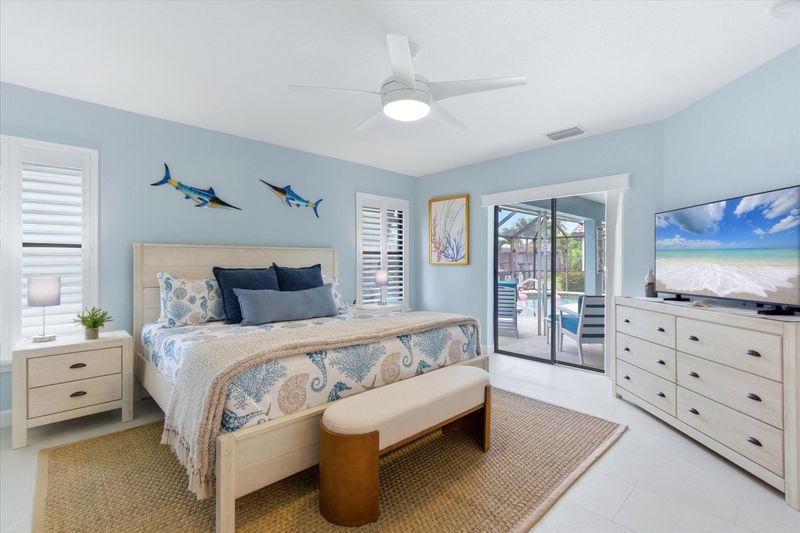 Bedroom 1 - primary bedroom with king bed, attached bathroom, lanai access, and 50" Smart TV