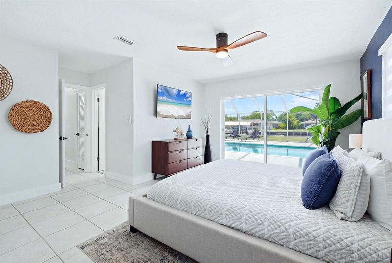 Primary bedroom with king bed, attached bathroom, lanai access and 55-inch Smart TV