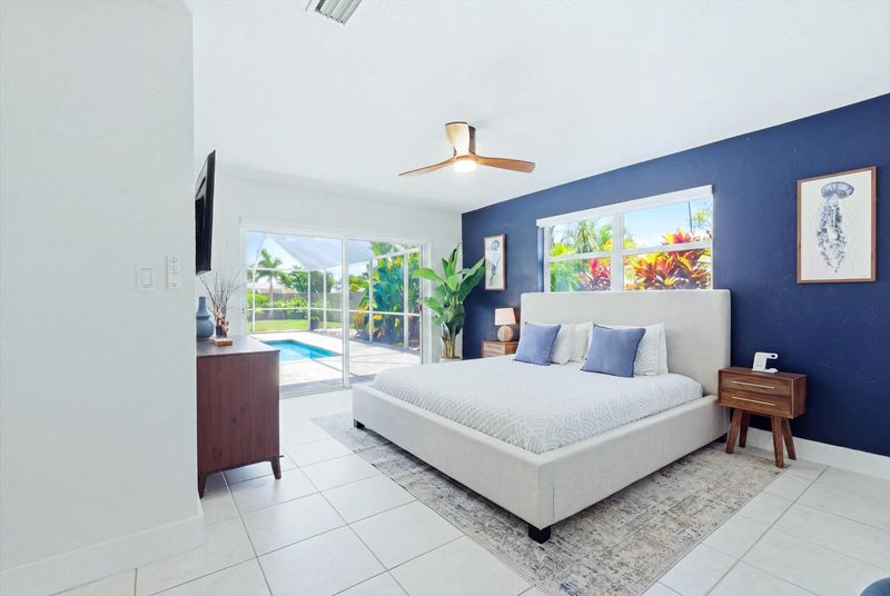 Primary bedroom with king bed, attached bathroom, lanai access and 55-inch Smart TV