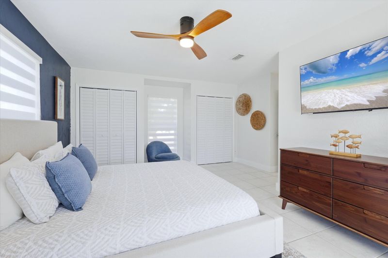 Primary bedroom with king bed, attached bathroom, lanai access and 55-inch Smart TV