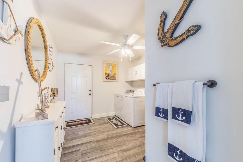 Attached bathroom with shower / tub combo and full size washer & dryer