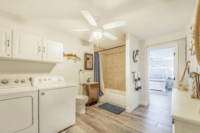 Attached bathroom with shower / tub combo and full size washer & dryer