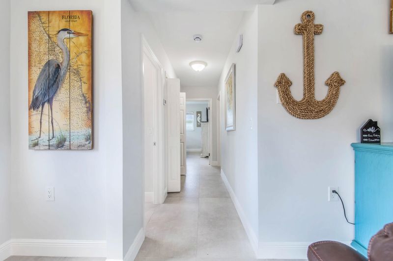 Hallway to primary bedroom and guest bedroom 1