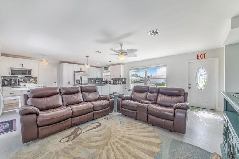 Living room with lanai access and 60-inch Smart TV