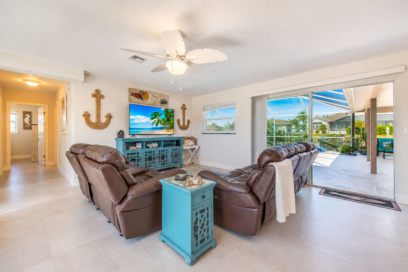 Living room with lanai access and 60-inch Smart TV