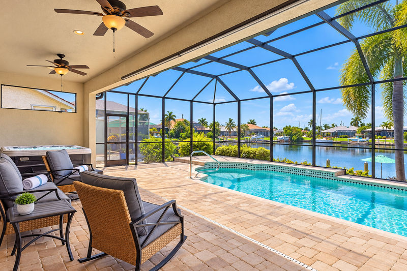 Gorgeous outdoor living space overlooking the sparkling private pool and canal beyond. Great for entertaining.