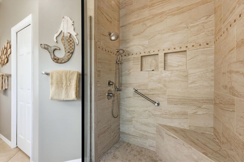 Attached bathroom with large walk-in shower and double vanities