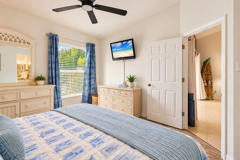 Primary bedroom with king bed, attached bathroom and 37-inch TV